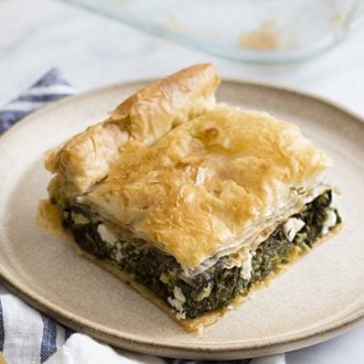 A close up photo of Spanakopita on a tan plate