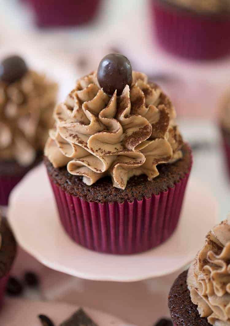 Lots of mocha buttercream and a chocolate-covered espresso bean top a chocolate cupcake