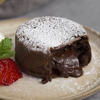 A chocolate lava cake with chocolate flowing from inside