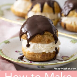 Pinterest graphic of profiterole on a plate with chocolate drizzled on top with more in the background.