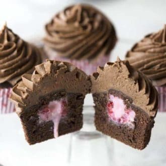 A photo of a Raspberry Surprise Cupcakes cut in half.