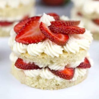 A Strawberry Layer Cake with fresh strawberries on top.