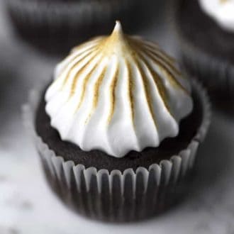 a chocolate cupcake on a white marble table
