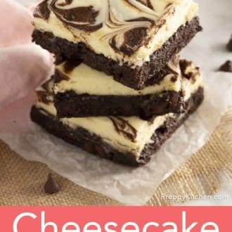 stack of cheesecake brownies on parchment