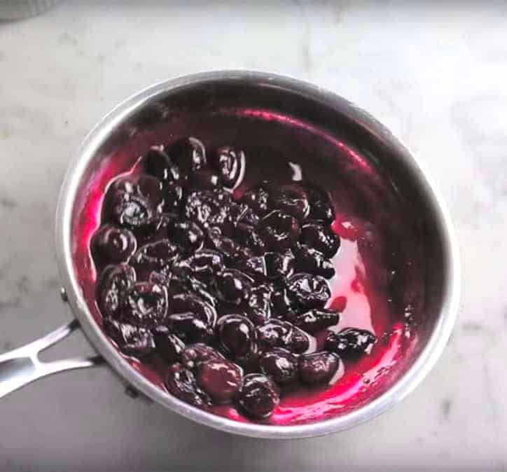 A pan filled with a reduced mixture of cherries