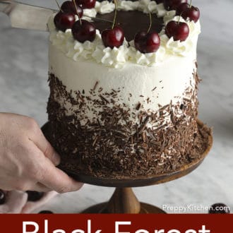 black forest cake on a stand being cut