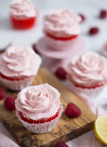 A photo showing a group of cupcakes topped with pink buttercream roses.