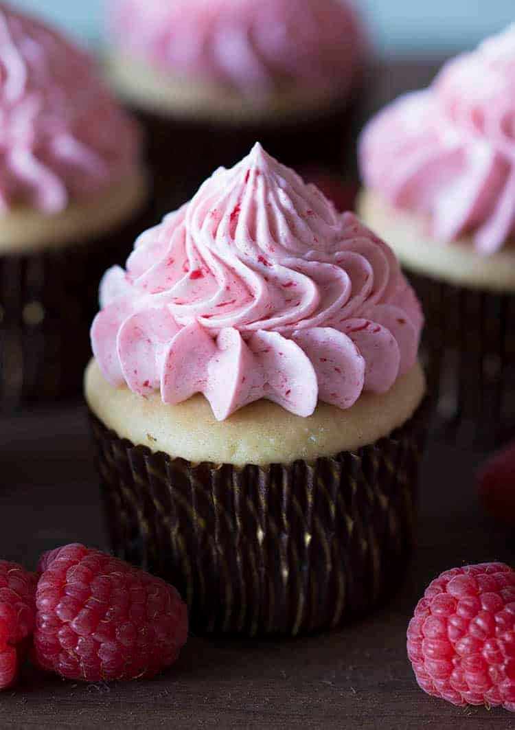 A peanut butter cupcake with a raspberry jelly buttercream dollop