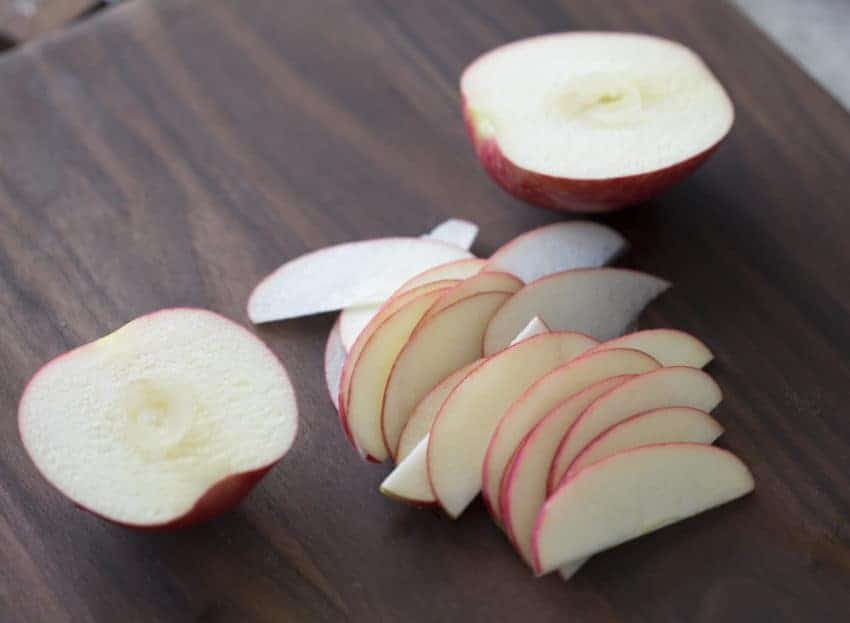 A photo of apples cut up into very, very thin slices.