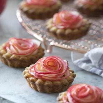An apple is peeled and rolled up to look like a single rose and baked into a rose apple tart.