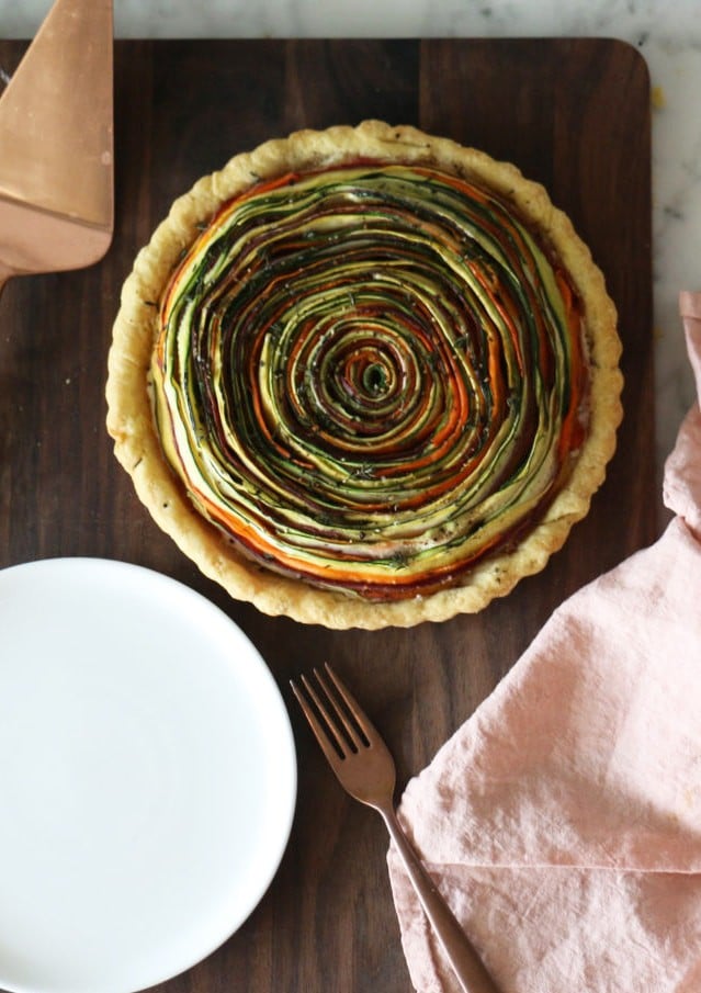 Photo of vegetable tart shot from above on a dark wooden board