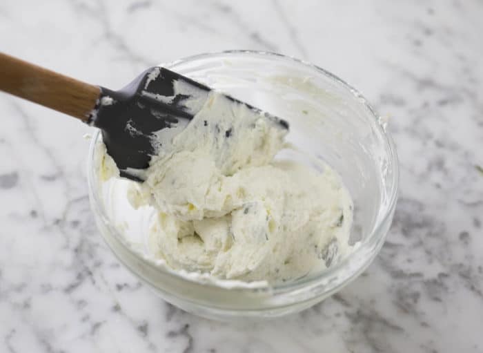 Photo of goat cheese filling being mixed in a glass bowl