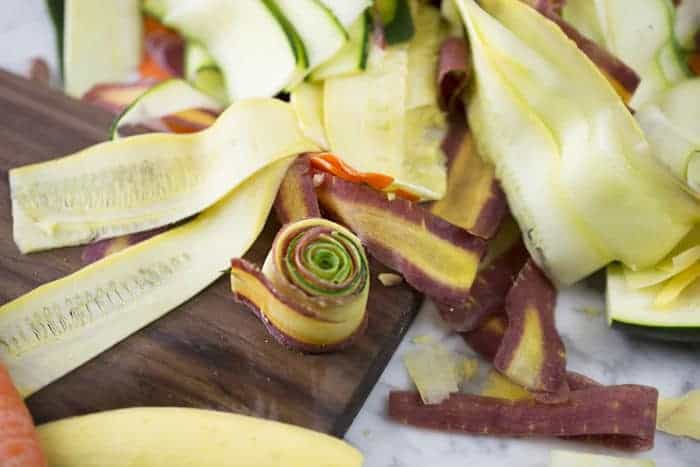 Photo of thinly sliced vegetables being rolled into a spiral