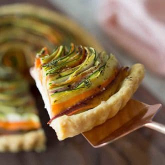 A slice of vegetable tart lifted from the whole tart.