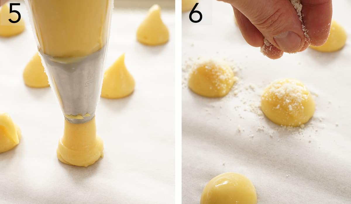 Choux dollops getting sprinkled with cheese before baking.