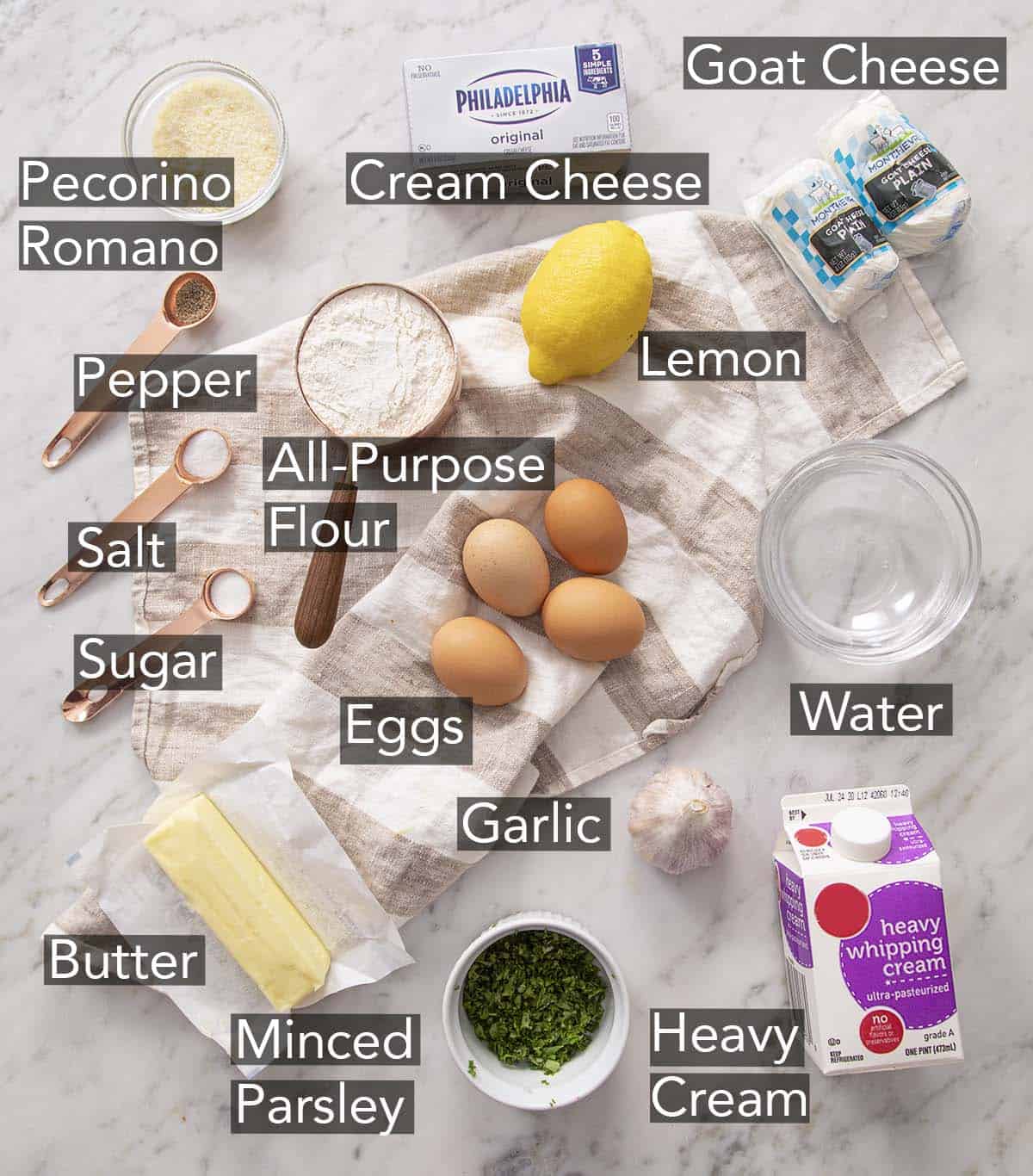 Ingredients to make cheese puffs on a marble table.