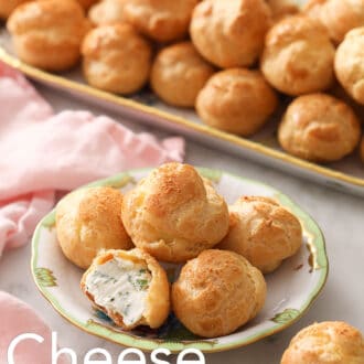 Many cheese puffs on a plate.