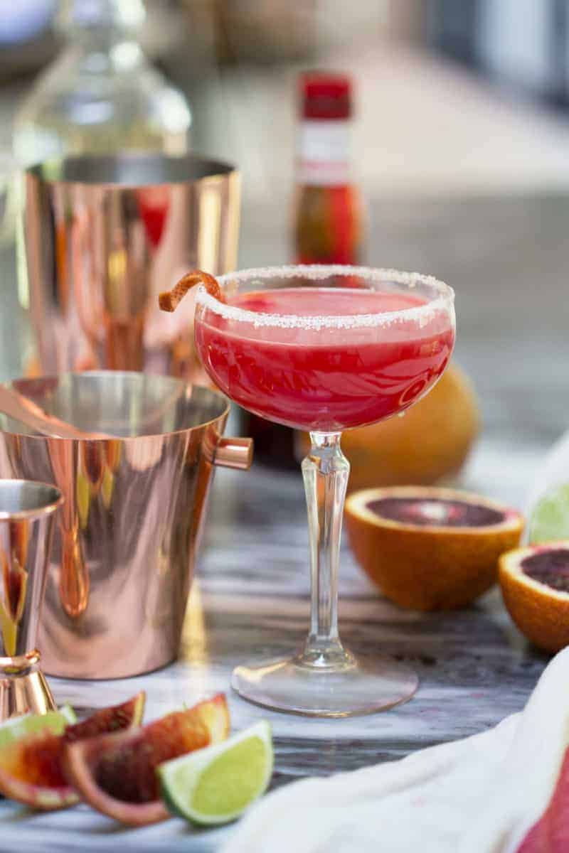 A photo of a blood orange margarita with a twist.