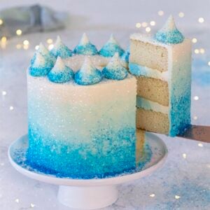 A photo of a blue ombre cake with a piece coming out.