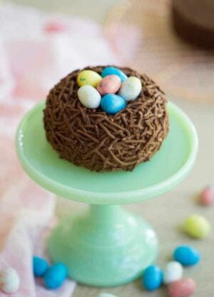A photo of a Bird’s Nest Easter Cake on a mini cake stand.
