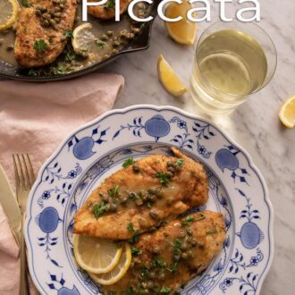 Pinterest graphic of a plate with two servings of chicken piccata by a cast iron pan.