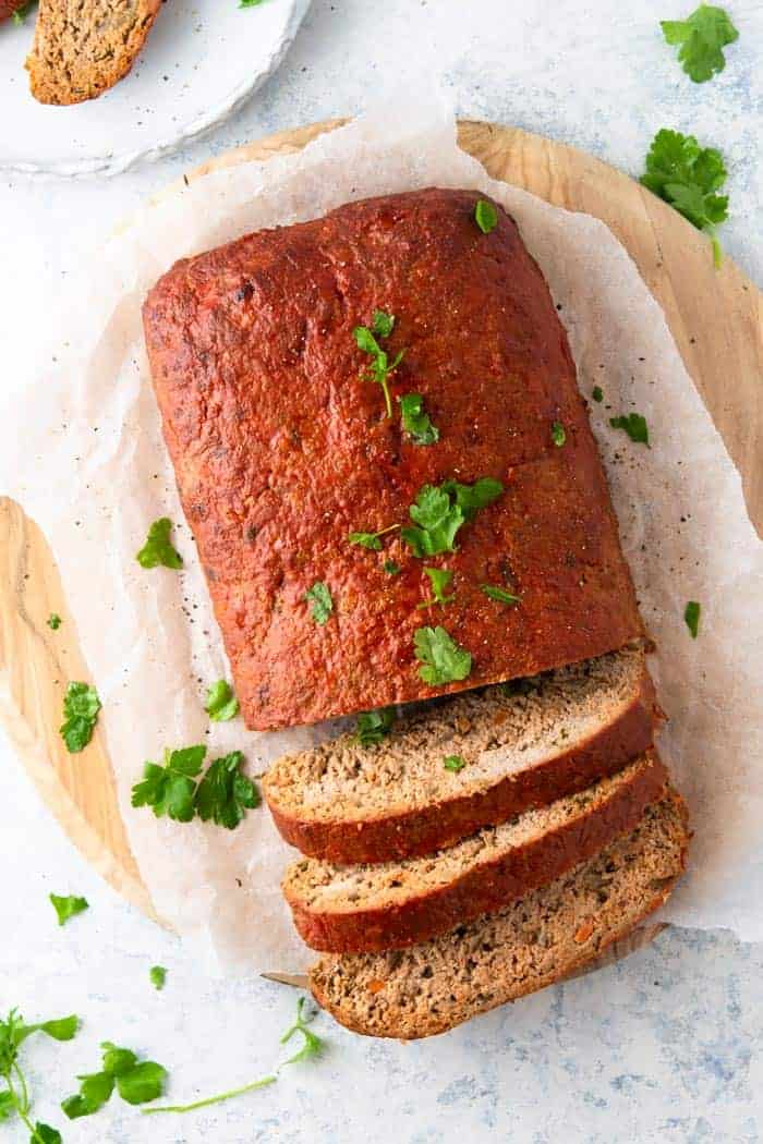 A photo of turkey meatloaf with parsley garnished on top.