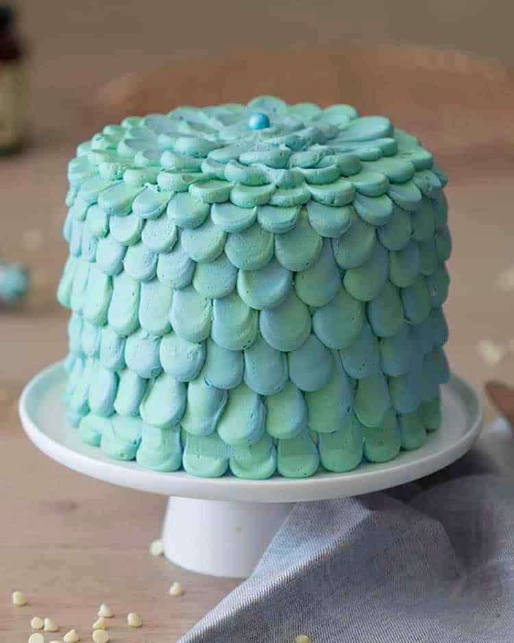 A blue and green scaled three layer cake