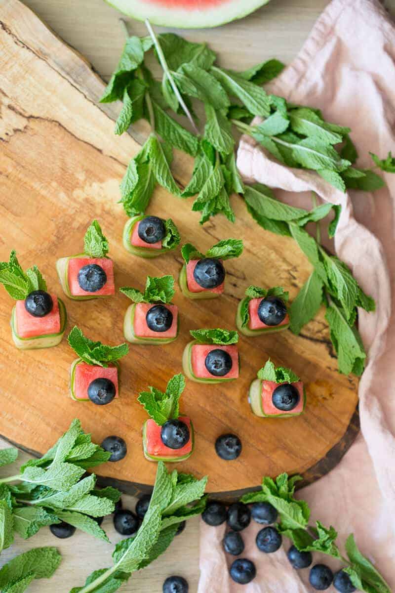 A photo of watermelon Canapés on a cutting board.
