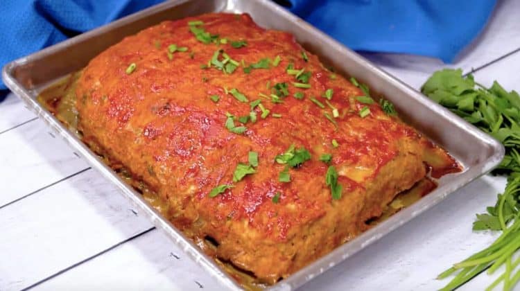 A photo of turkey meatloaf fresh out of the oven and garnished with parsley.