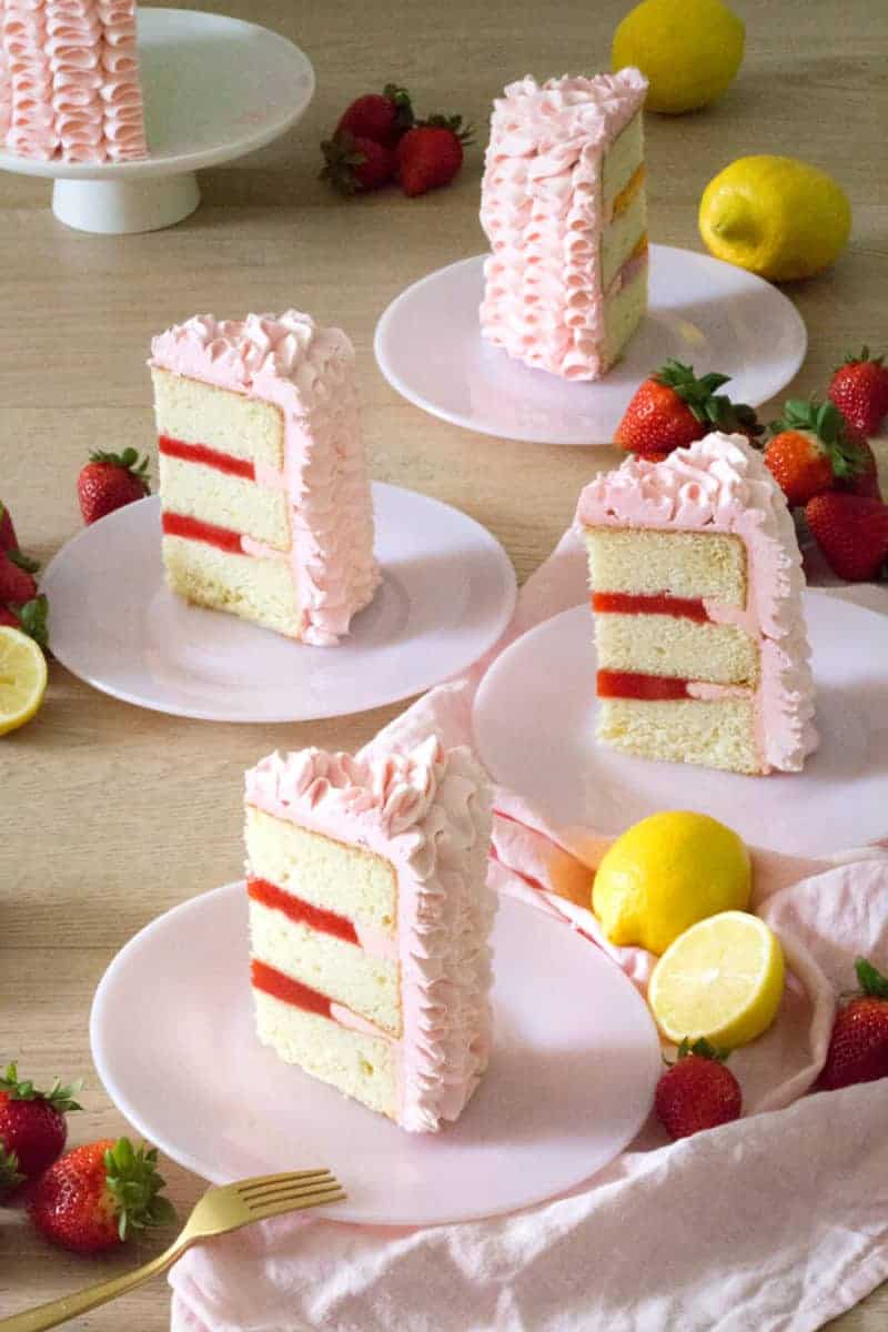 A photo showing multiple slices of strawberry lemon cake on plates.