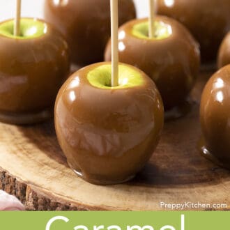Pinterest graphic of caramel apple on a wooden serving board.