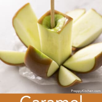 Pinterest graphic of a chopped caramel apple on parchment paper.
