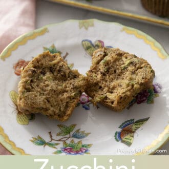 Zucchini muffin split in half on a plate