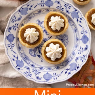 Three mini pumpkin pies on a blue and white plate.