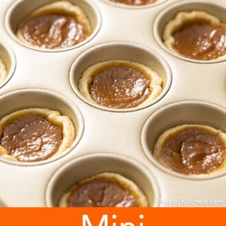 Freshly baked Mini pumpkin pies in a baking tin.