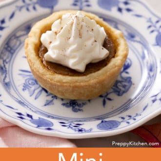 A mini pumpkin pie on a blue and white plate.