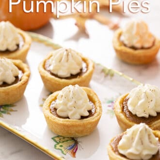 Mini pumpkin pies on a marble counter.