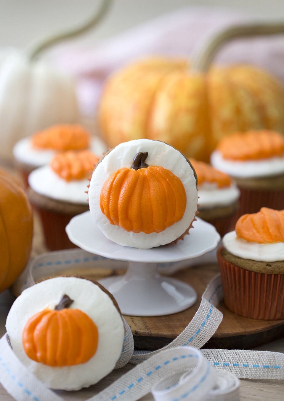 Pumpkin Spice Cupcakes with buttercream pumpkins on top.