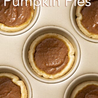 Mini pumpkin pies in a golden baking pan.