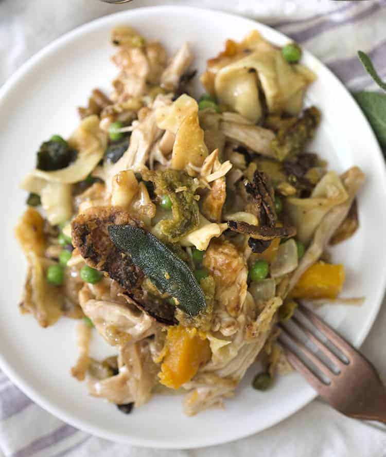 A plate of turkey casserole with sweet potatoes, peas and onions