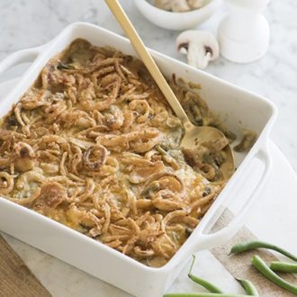 photo of green bean casserole with a gold serving spoon