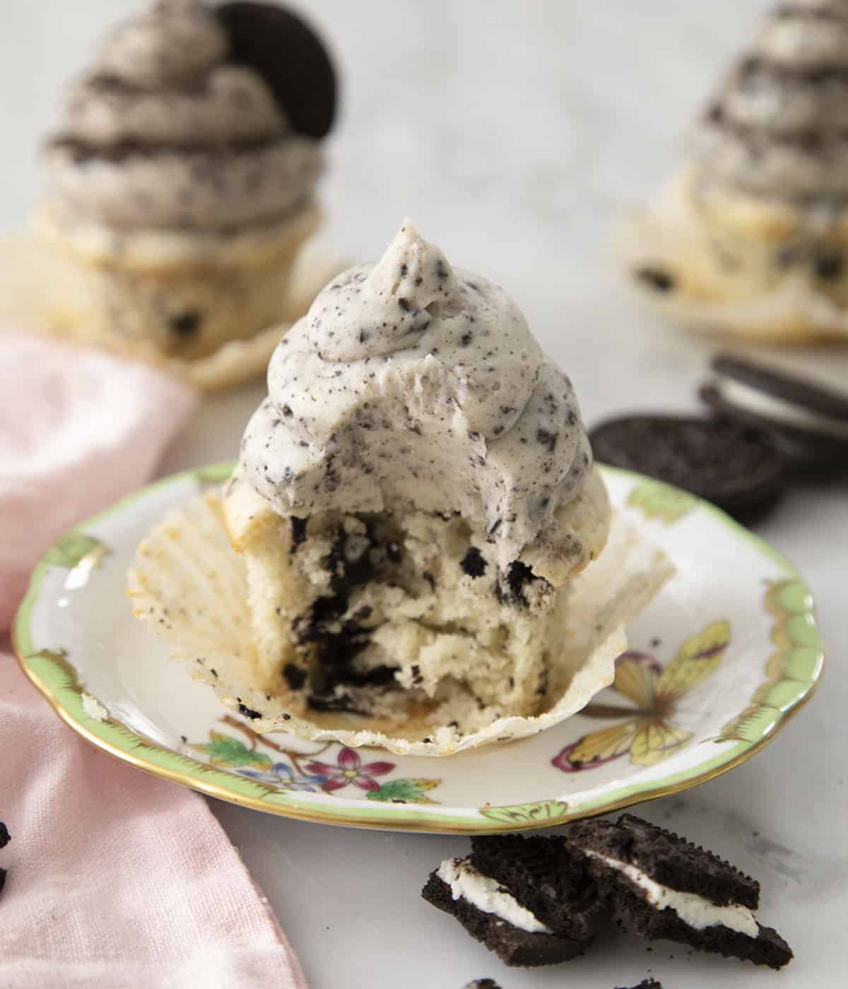 An Oreo cupcake with a big bite taken out of it.