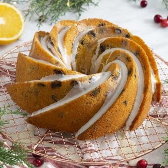 An olive oil bundt cake on a white marble table