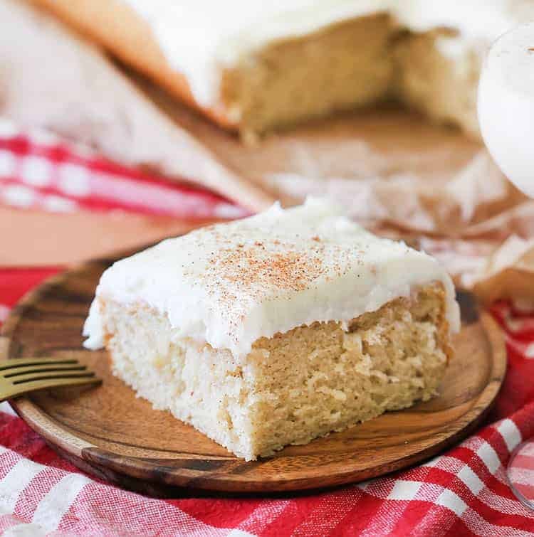A piece of eggnog cake on a wooden plate