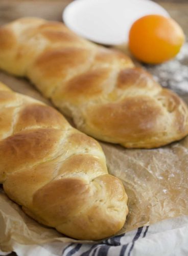 A photo of two loafs of greek braided bread.