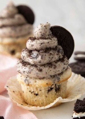 An Oreo cupcake topped with Oreo buttercream and crumbled Oreos.
