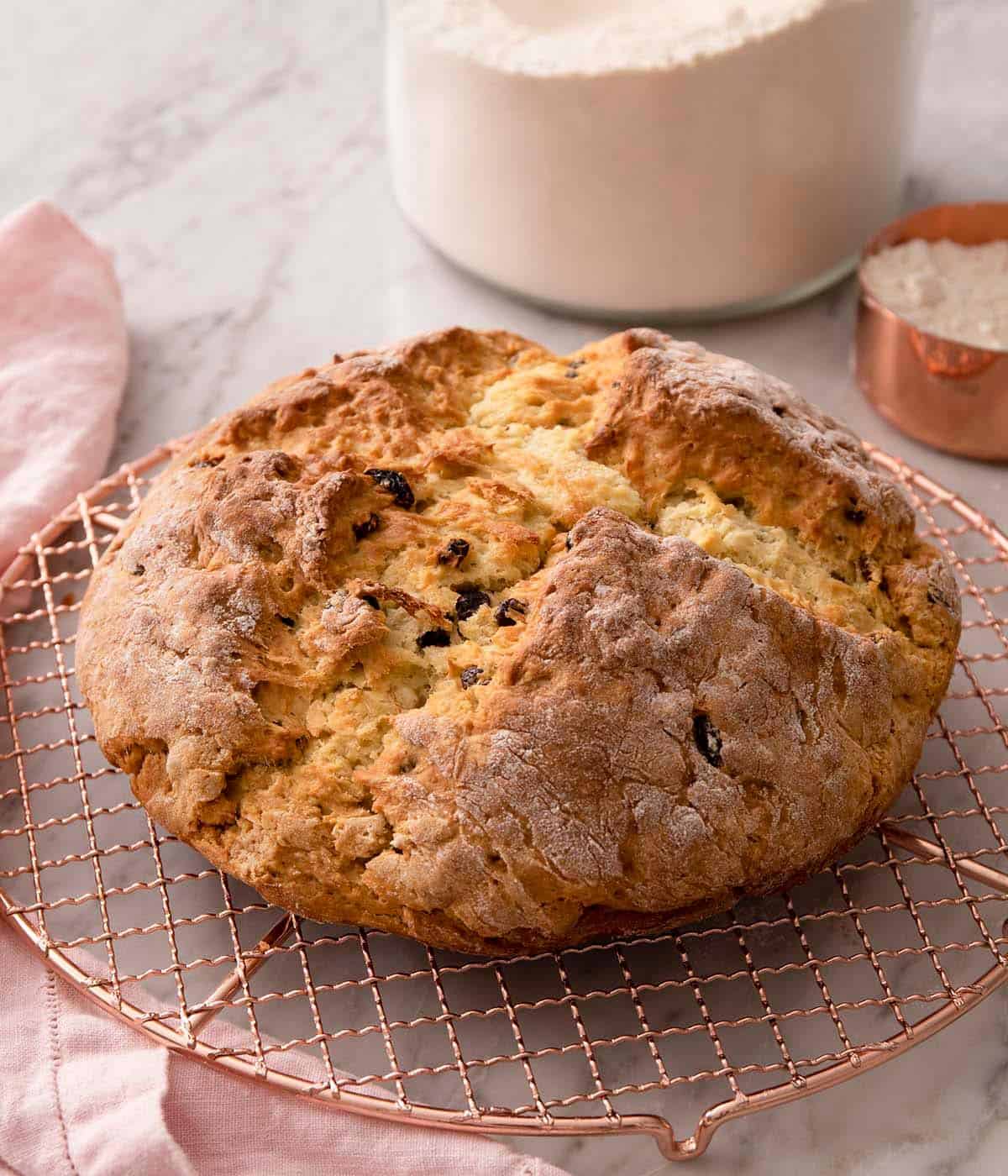 A loaf of Irish soda bread on a cooling rack