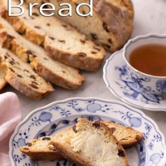 Pinterest graphic of a plate with slices of Irish soda bread with butter spread on it by a mug of tea.