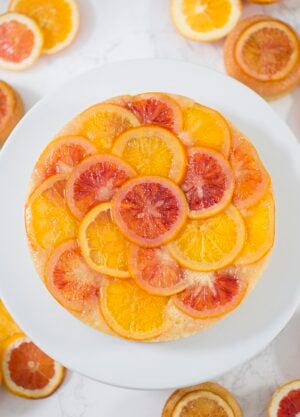 a top down photo of an orange upside down cake on a white cake strand