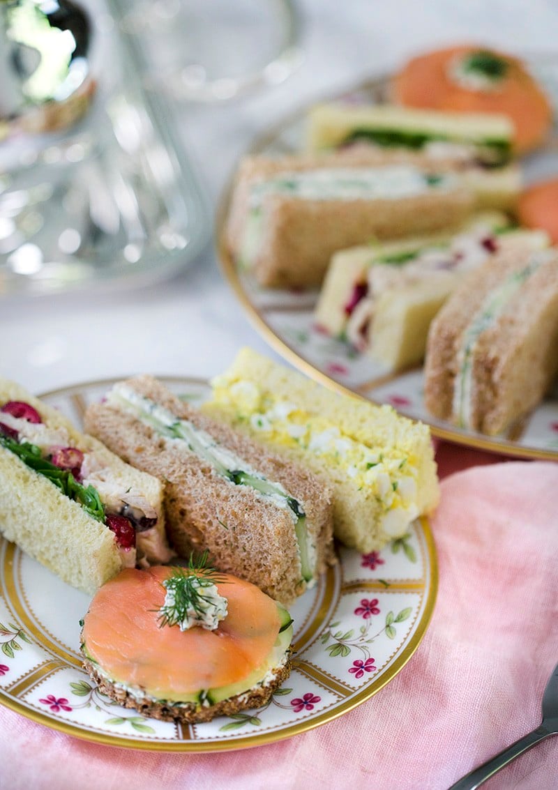 A photo showing English tea sandwiches arranged on a painted porcelain plate